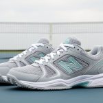 Close-up of women’s court sneakers on a tennis court, highlighting breathable mesh uppers and grippy rubber outsole for style and all-day comfort.